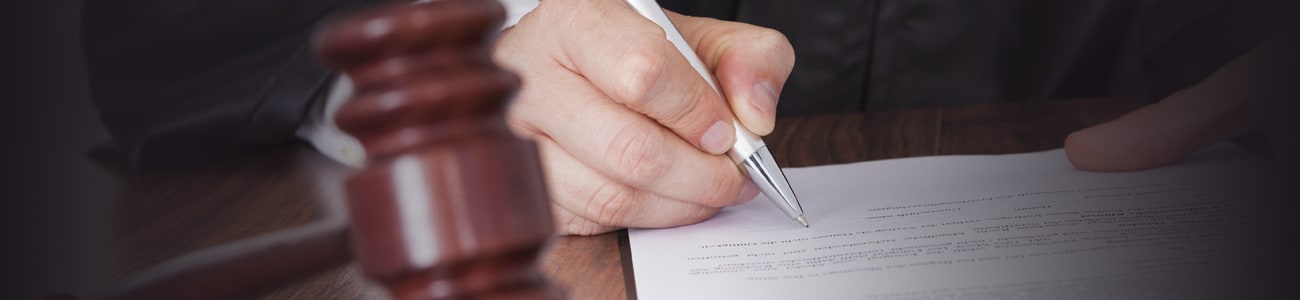 Banner picture of a judge signing papers