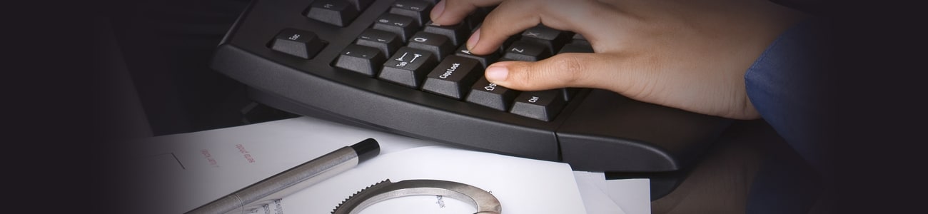 Banner picture of a person typing on a computer keyboard