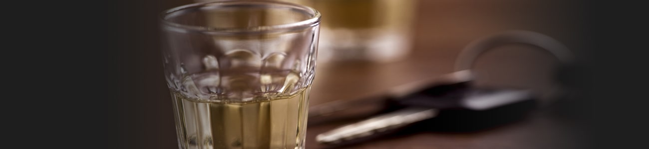 Banner picture of a glass with alcohol and car keys in the background