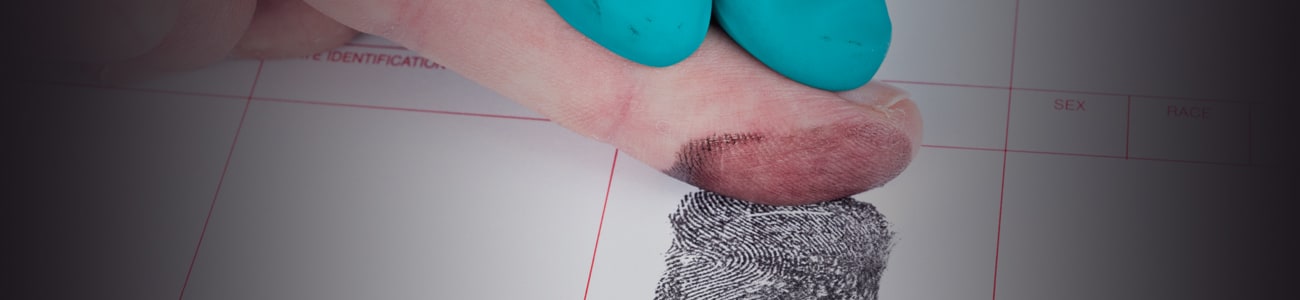 Banner picture of person taking the fingerprints of a suspect