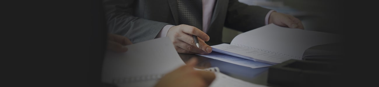 Banner picture of a person hold a paper report in hand