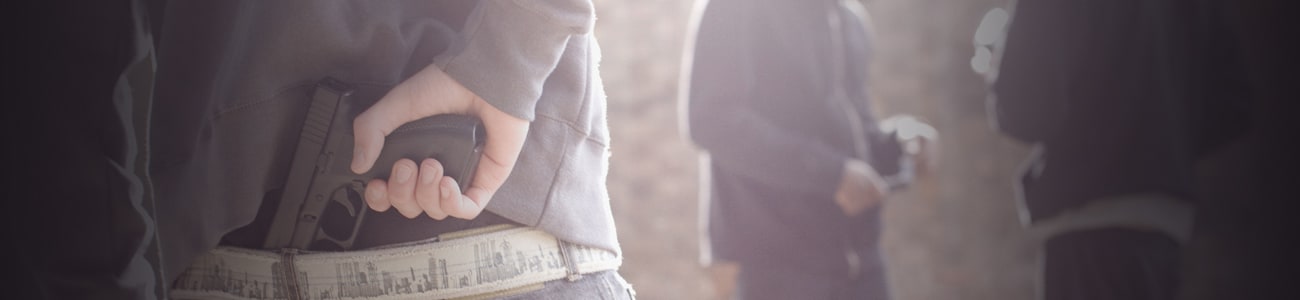 Banner picture of various persons with a gun