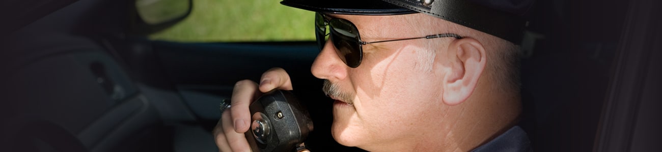 Banner picture of policeman holding a radio